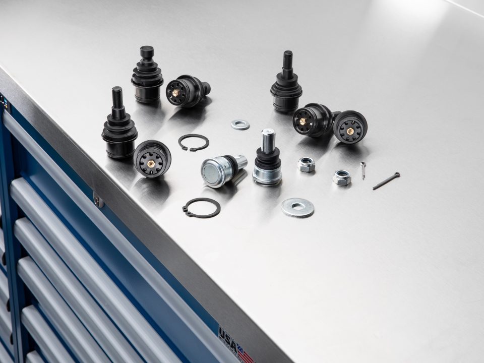 A selection of SuperATV ball joints on a workbench