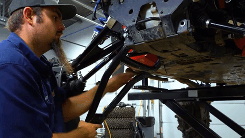 The lower A-arm comes free easily after Braden removes both the bolts.