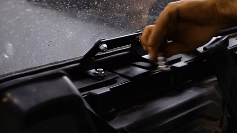 Braden fully tightens the bolts with a ratchet.