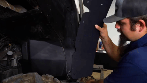 Braden aligns the fender flare with the underside of the rear OEM fender.