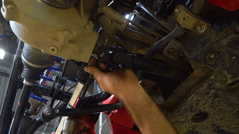 A hammer gently tap, tap, taps on a pin to remove it from the differential.