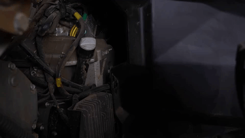 Braden uses a push pin removal tool to remove an OEM push pin next to the voltage regulator.