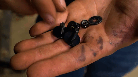 Braden sorts through a pile of SuperATV-branded nuts and bolts.