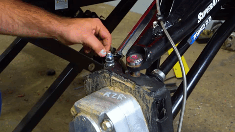 Braden uses pliers to remove a cotter pin from the tie rod end.