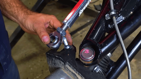 Braden slides the tie rod end over the tapered stud on the steering knuck.
