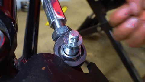 Braden tightens a nut onto the stud above the tie rod end.