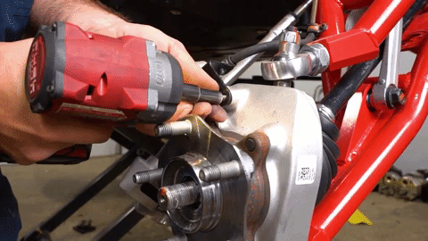Braden uninstalls a bolt from the brake line bracket.