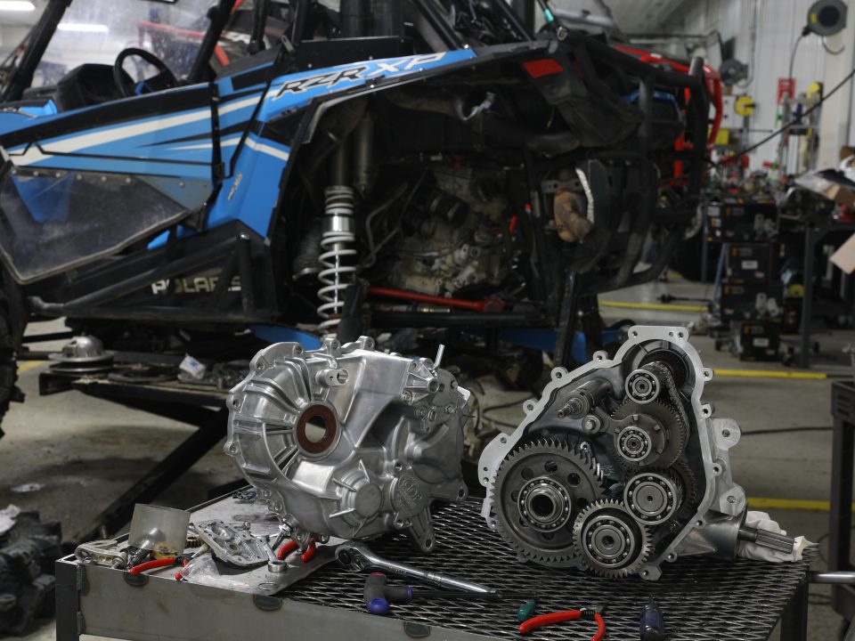 An open RZR transmission showing the output shaft and reverse chain.