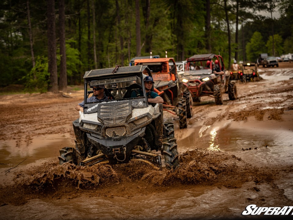UTVs riding in mud