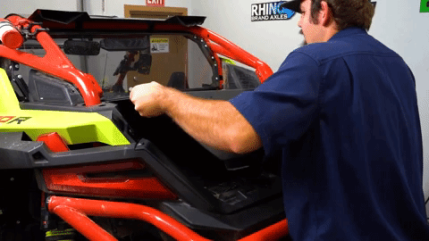Braden uses both hands to wiggle the bend enclosure into place.