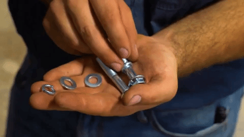 Braden slides a washer along a long bolt.
