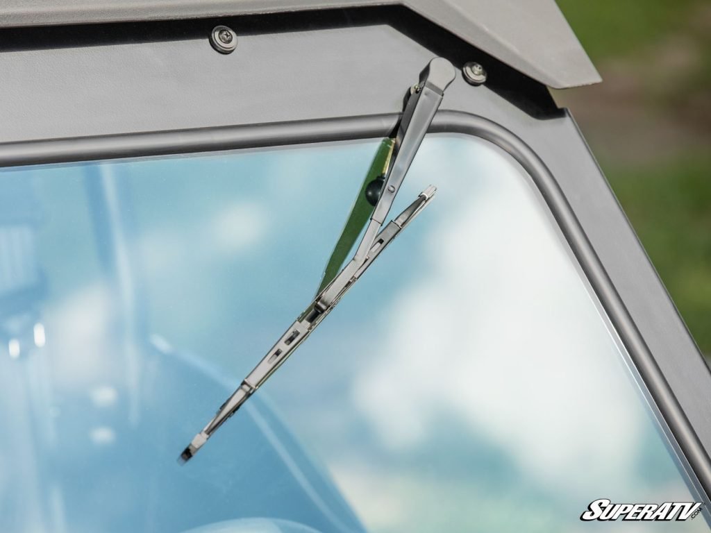 A close up shot of a manual windshield wiper on a UTV windshield.