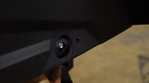 You can see a bolt right at the edge of a hole in the frame.