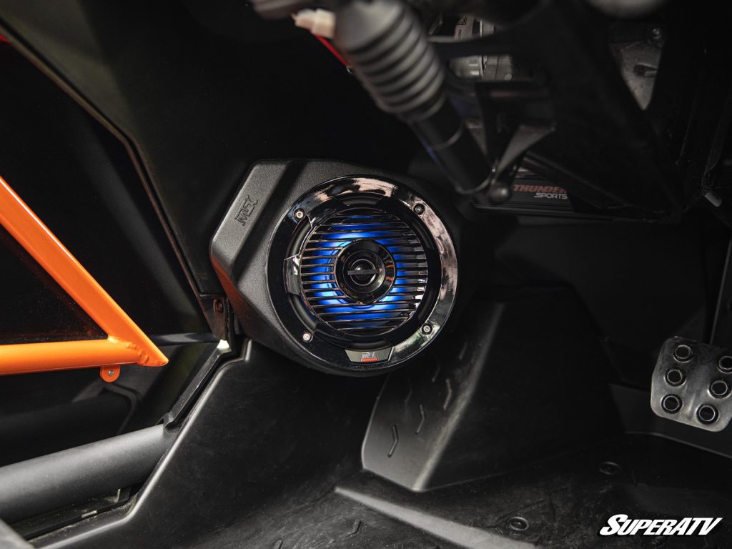 A close shot of a an MTX speaker with customizable LEDs installed in a UTV door.