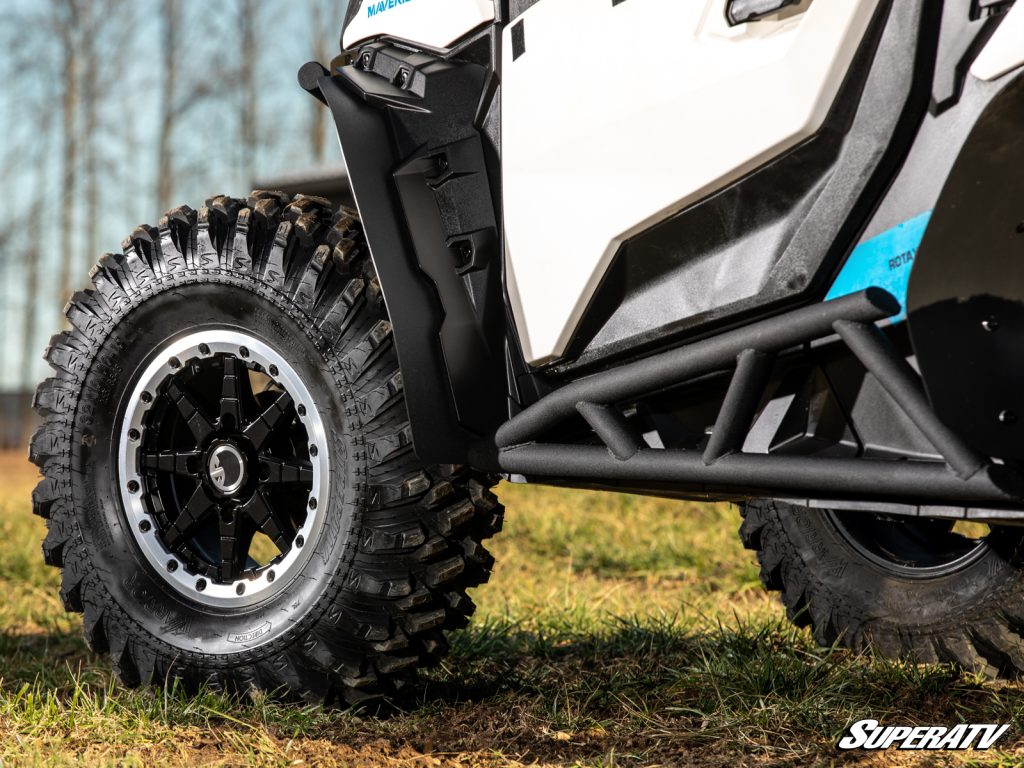 A close-up of fender flares right next to heavy-duty nerf bars.