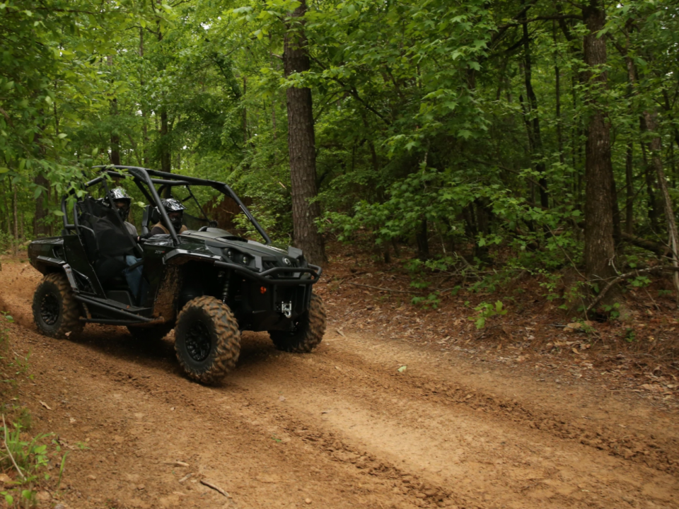 A 2021 Can-Am Commander going fast on a trail