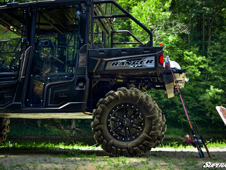 Side view of a Polaris Ranger against a forest background.