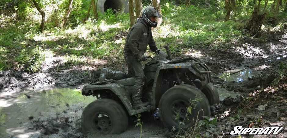 mudding on ATV in woods