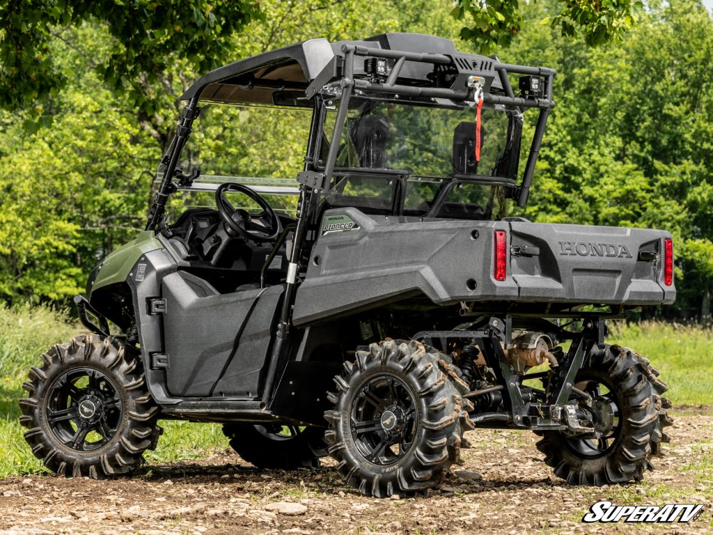 A Honda Pioneer with a SuperATV game loader rack.