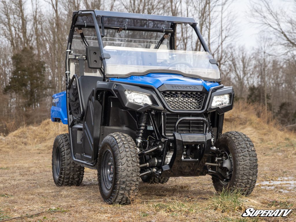 A Honda Pioneer with a SuperATV half windshield, roof, and rear windshield.