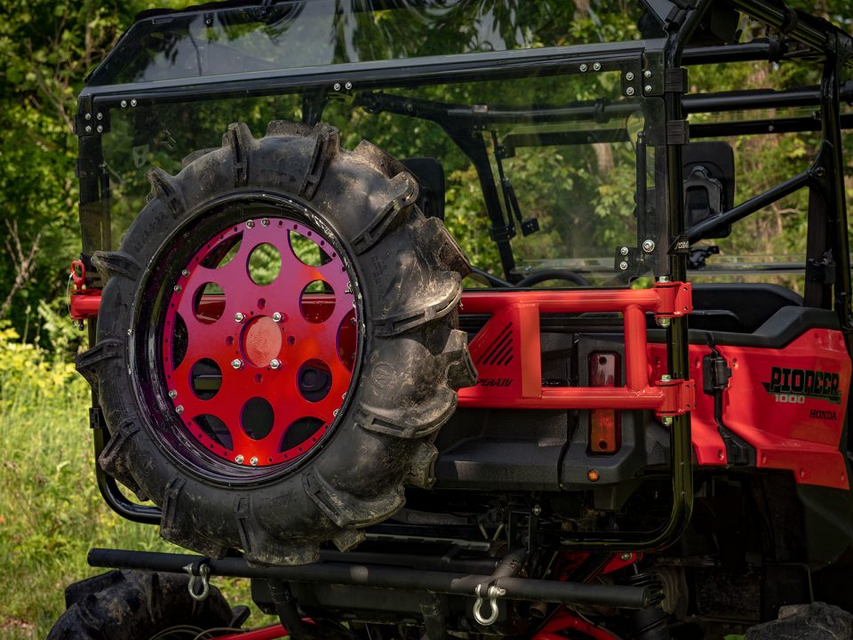 A spare tire carrier installed on a Honda Pioneer 1000-5
