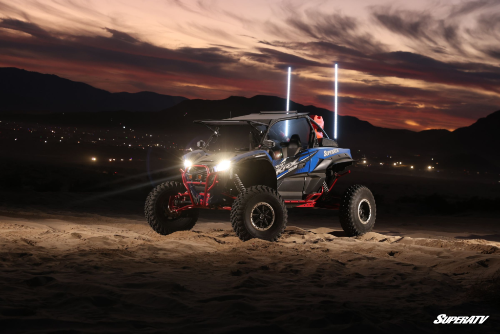A Kawasaki KRX sitting in the desert at night.