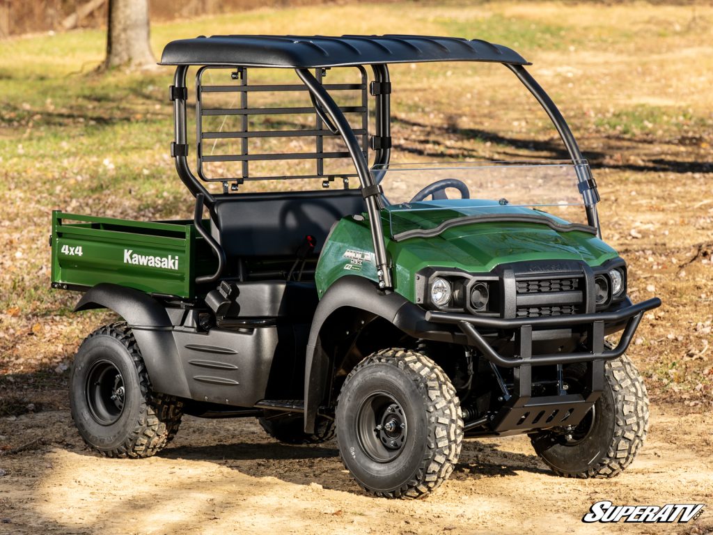 A Kawasaki Mule parked on a dirt path.