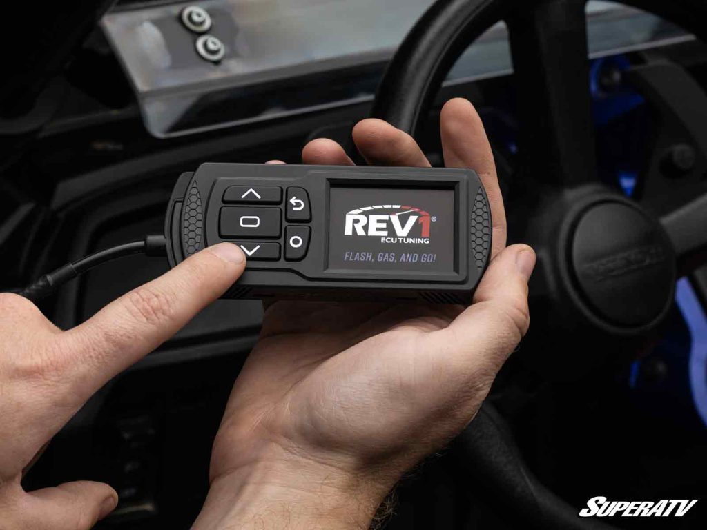 A close shot of a Rev1 tuner held in a person's hand.