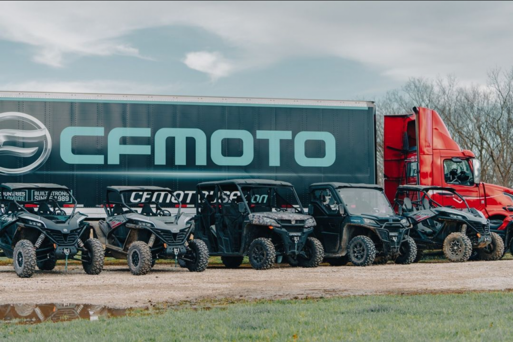 CFMOTO truck and trailer with CFMOTO lineup in front of it