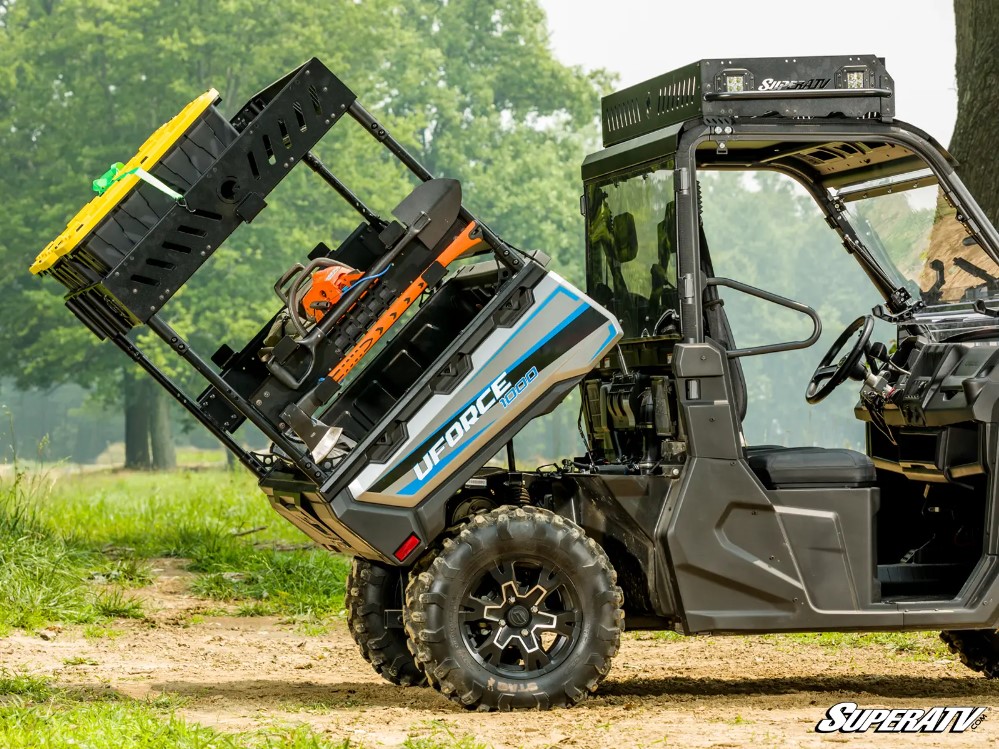 A CFMOTO Uforce tilts the dump bed with an Outfitter Bed Rack equipped.