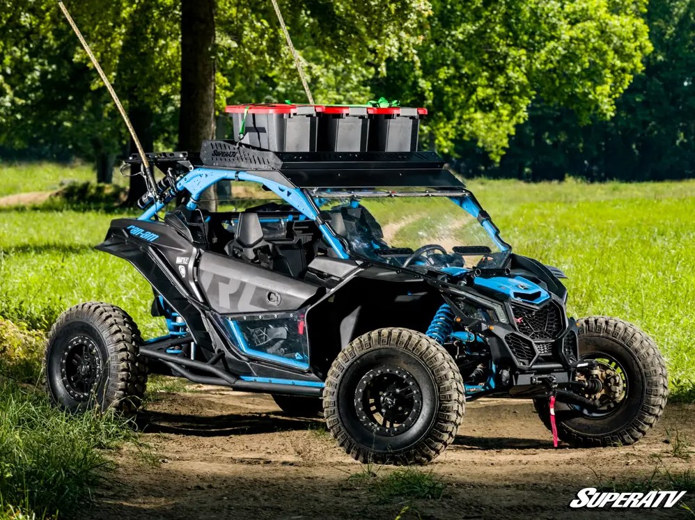 A Can-Am Maverick X3 with an Outfitter Roof Rack installed and loaded with cargo.