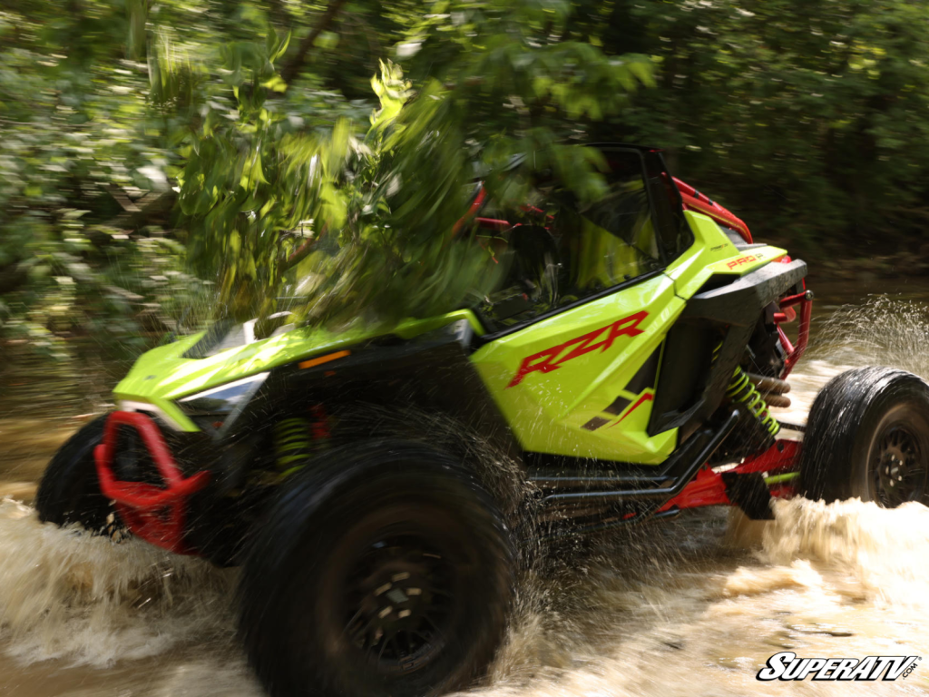 A Polaris RZR getting hit by tree branches