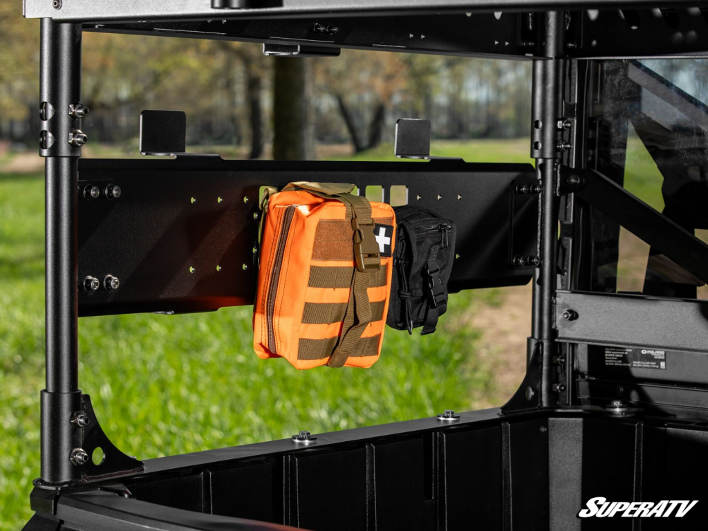 A first-aid kit is secured to a MOLLE panel on SuperATV's Outfitter Bed Rack.