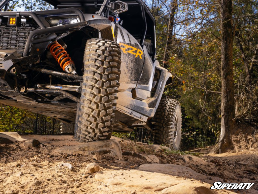 A Polaris RZR perched on a small rocky outcrop.