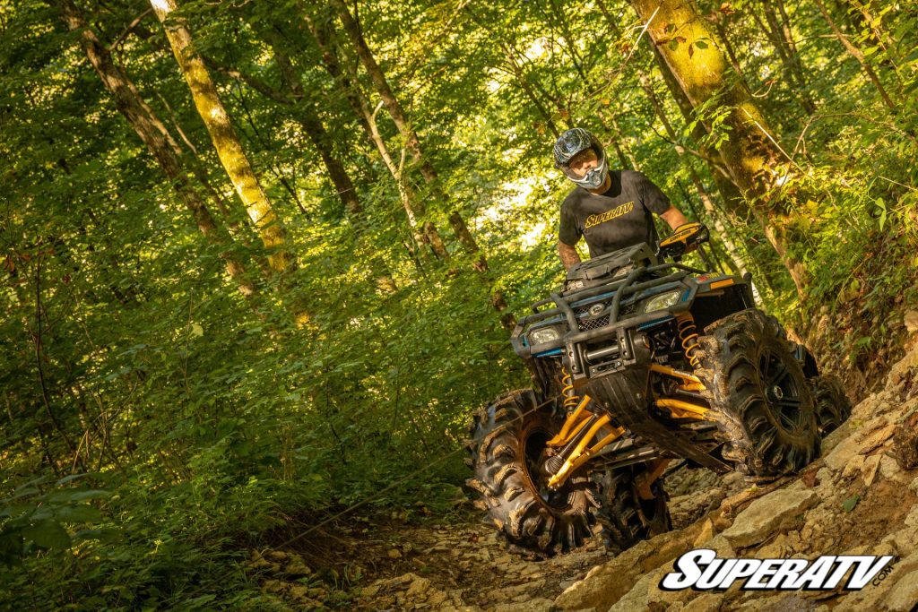 An ATV on a trail winching out of a tough spot.