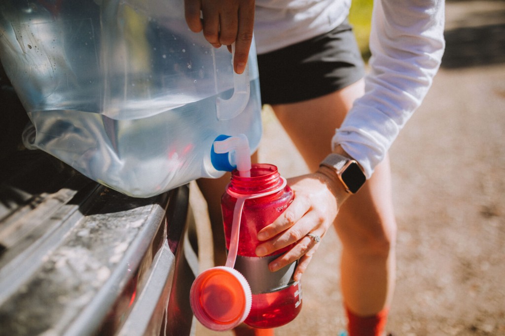 filling water bottle from water jug