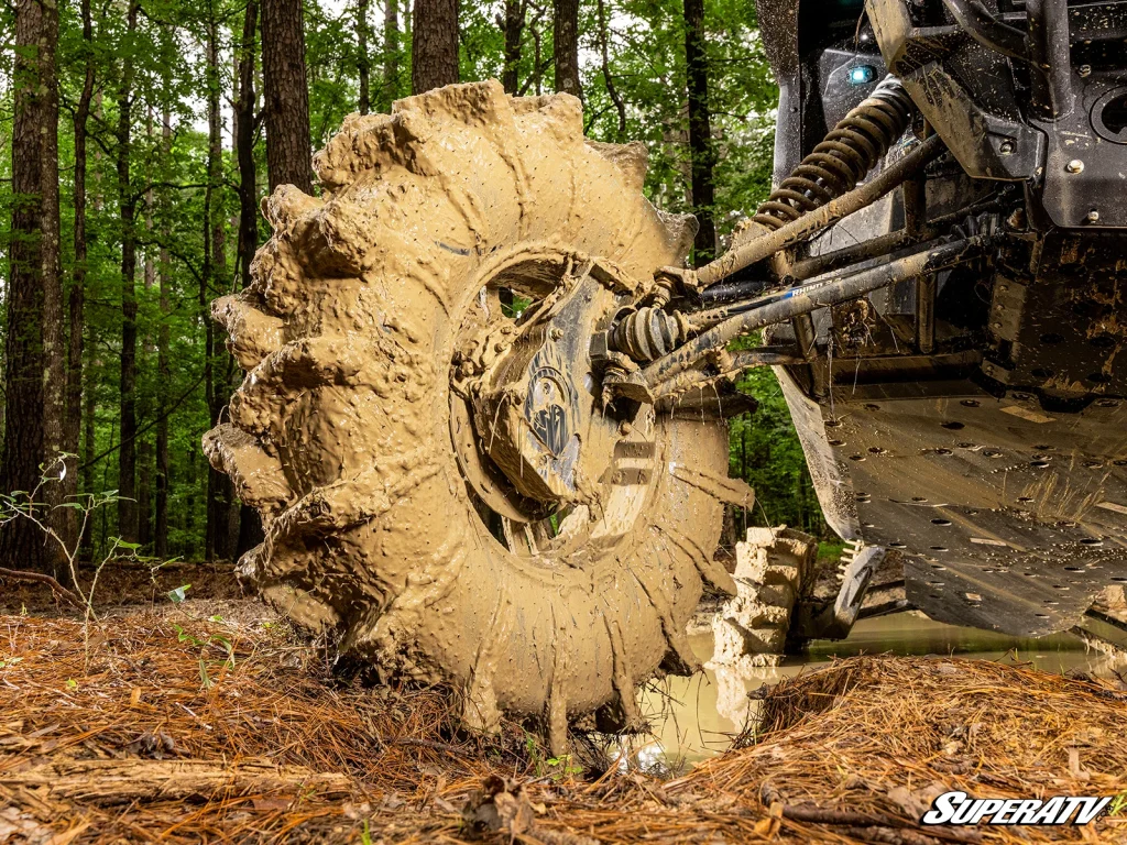 A mud-soaked tire, brake, and suspension components.