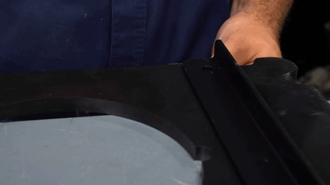 A man installs a bolt through a bracket to hold it steady.