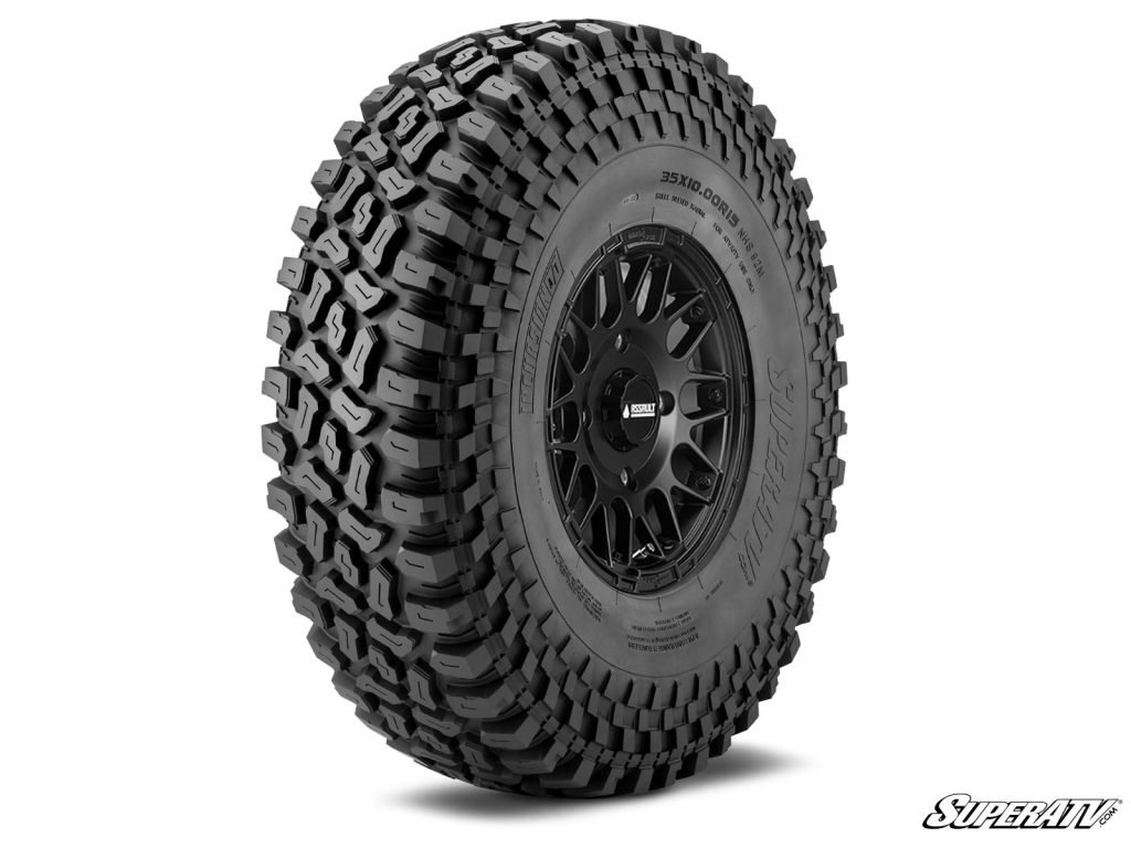 A SuperATV Incursion tire posed at an angle showing off the lugs and the rim.