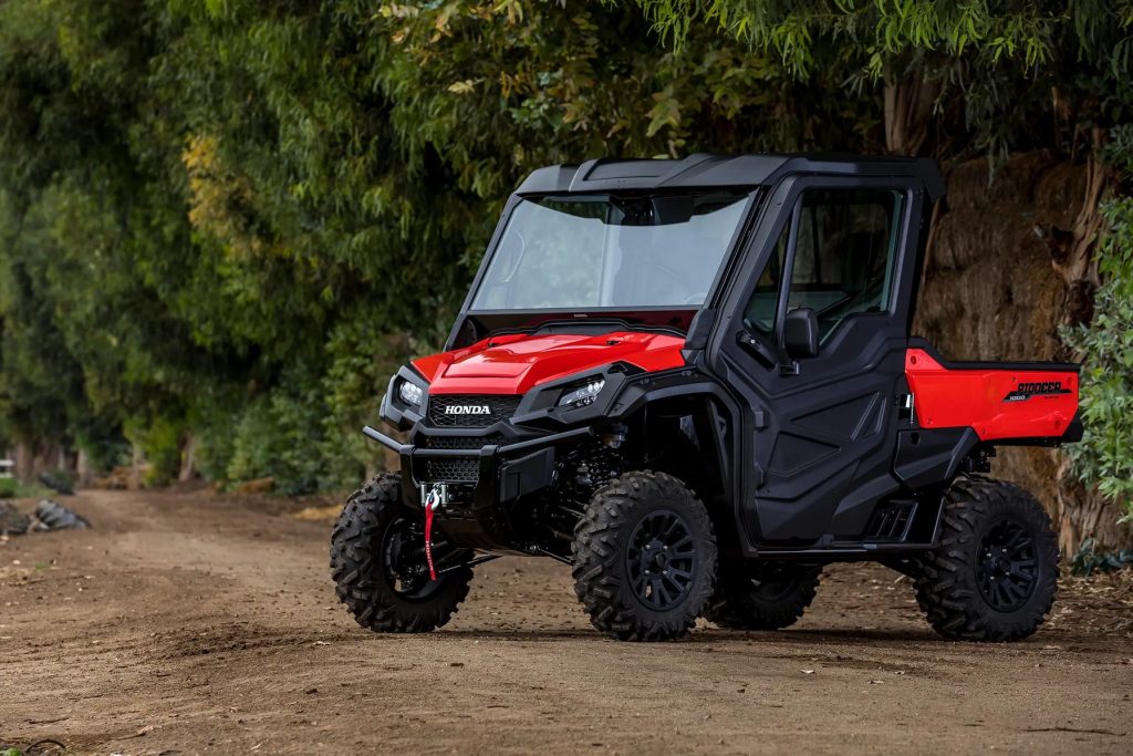 Honda Pioneer 1000 parked on trail in woods