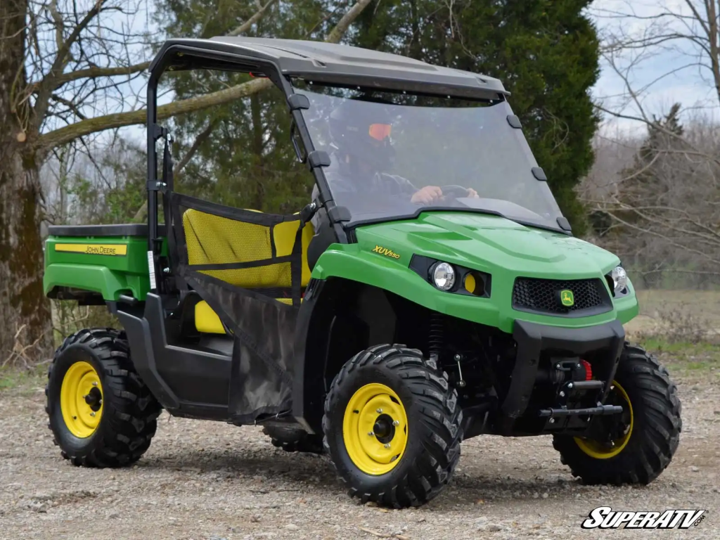 A John Deere Gator in the woods.