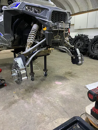 A RZR on a lift with 8" GDP Portals