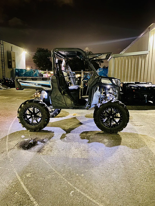 A CFMOTO UForce with 6" GDP Portals in a parking lot