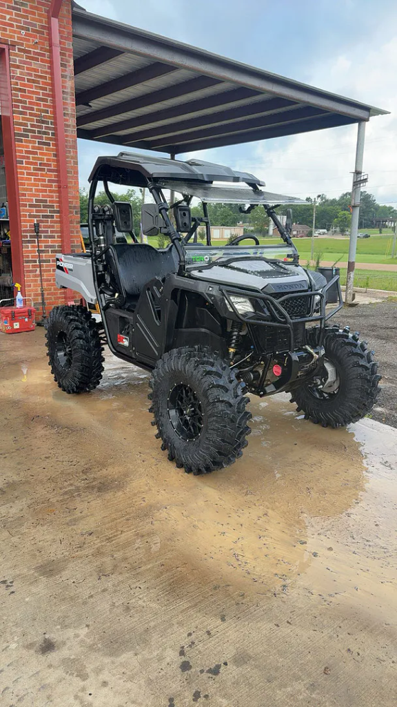 A honda pioneer in a driveway sporting 4" GDP Portals