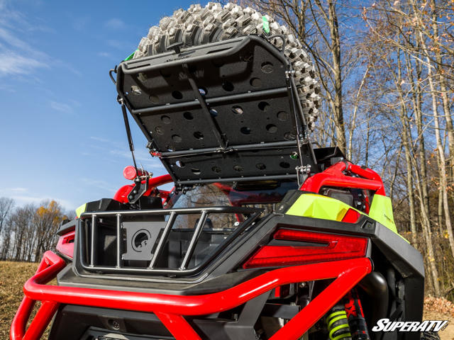 SuperATV's Cargo Rack Alpha showing how it folds up with a tire mounted to give you acces to the bed