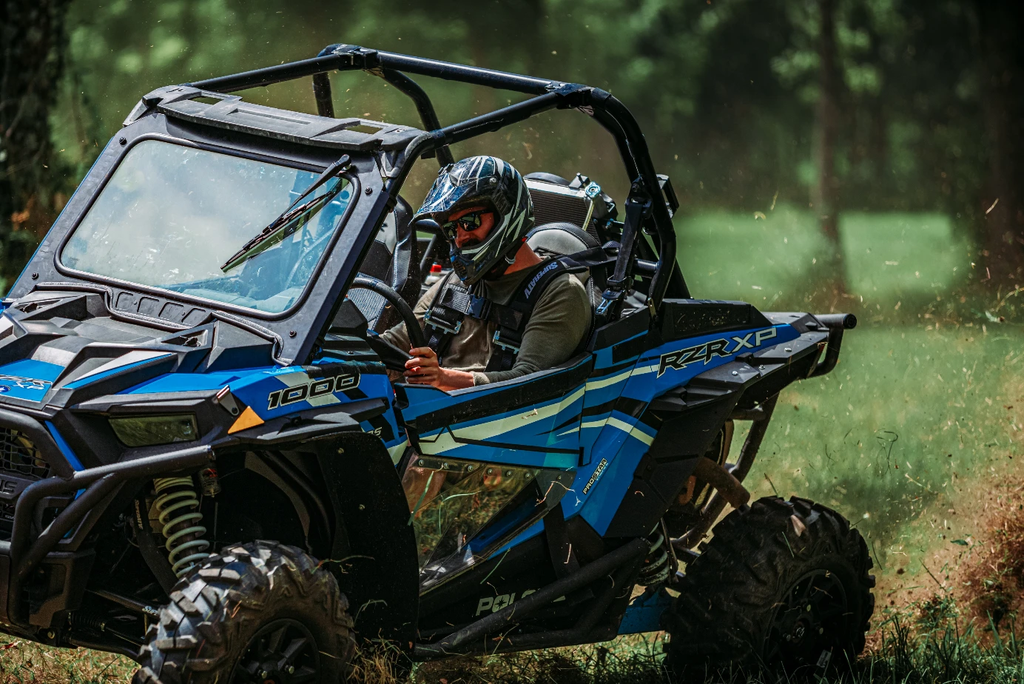 A RZR XP 1000 with a SuperATV Glass Windshield installed