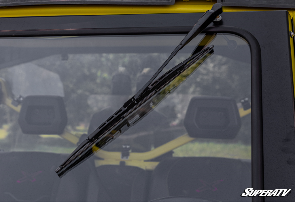 A closeup of SuperATVs manual windshield wiper on a glass windshield