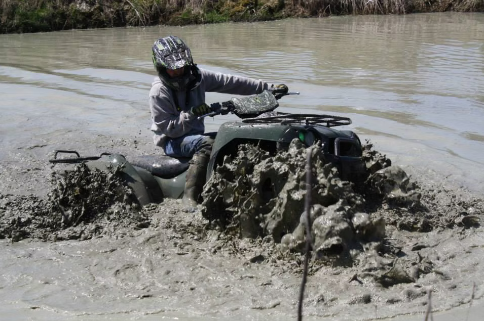 An ATV  navigating deep mud at Demon Run ATV Trails