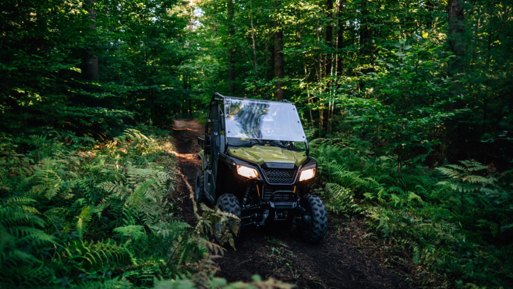 A Honda Pioneer on a loose dirt trail