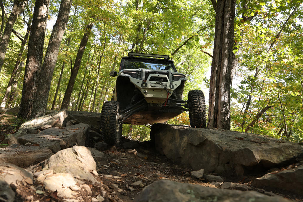 A UTV coming down an off-campre obstacle on rattler ridge in leatherwood off-road park